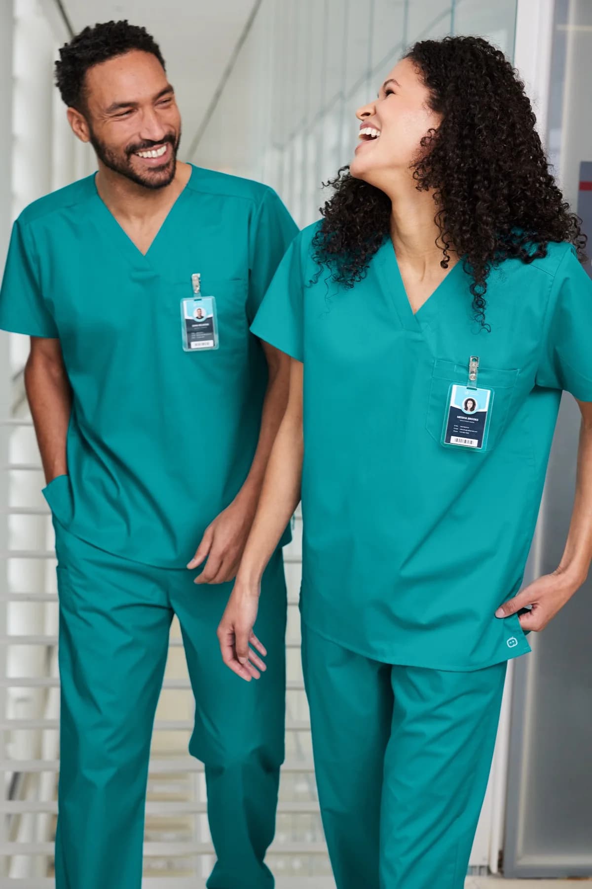 Healthcare coworkers wearing coordinated Wink scrubs